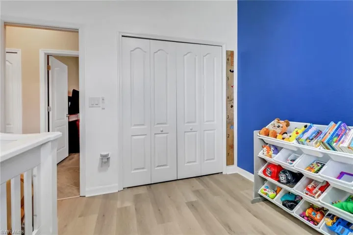 Playroom featuring baseboards and wood finished floors