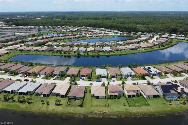 Drone / aerial view with a residential view and a water view