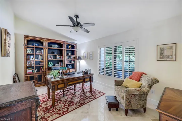 Tiled office with vaulted ceiling and ceiling fan