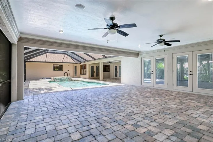 View of pool featuring ceiling fan, french doors, and a patio area