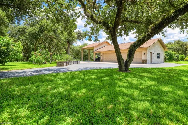 Single story home featuring a front yard and a garage