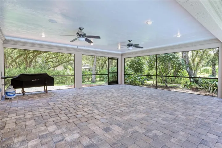 Unfurnished sunroom featuring ceiling fan