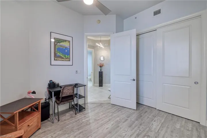 Office area with ceiling fan and light hardwood / wood-style floors