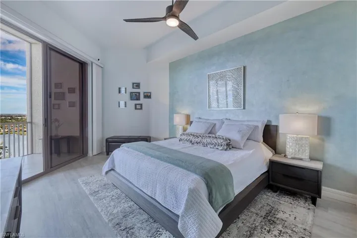 Bedroom with access to outside, light wood-type flooring, and ceiling fan