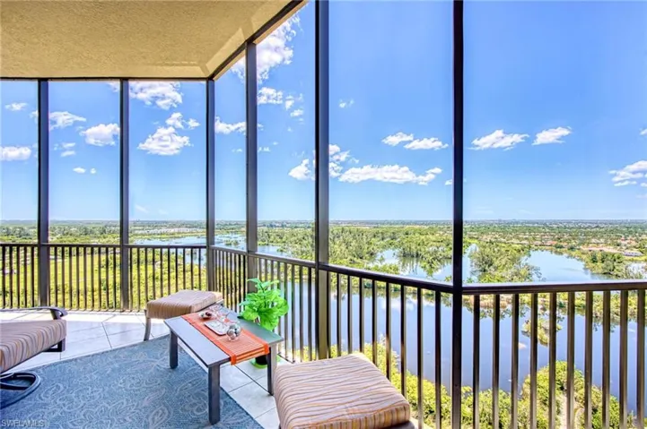 Sunroom featuring a water view and a wealth of natural light