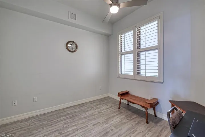 Sitting room featuring light hardwood / wood-style floors and ceiling fan