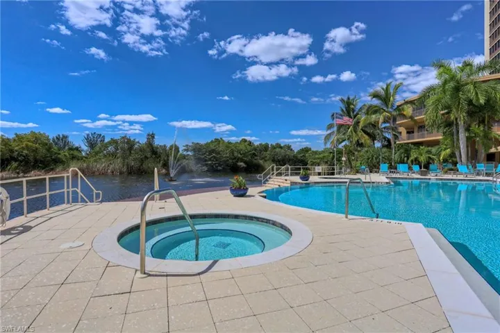 View of pool with a hot tub