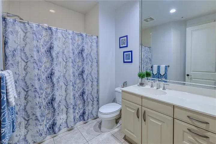 Bathroom with vanity, tile patterned flooring, and toilet