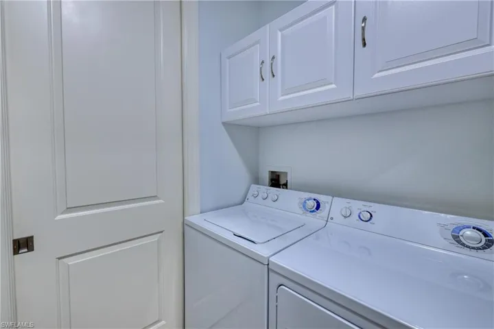 Clothes washing area with washing machine and dryer and cabinets