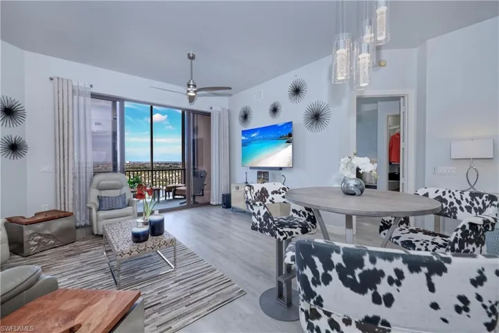 Living room with hardwood / wood-style flooring and ceiling fan