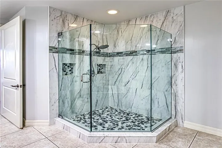 Bathroom with tile patterned flooring and walk in shower