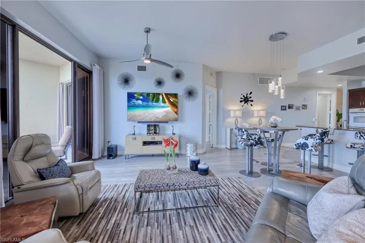 Living room with light hardwood / wood-style flooring and ceiling fan