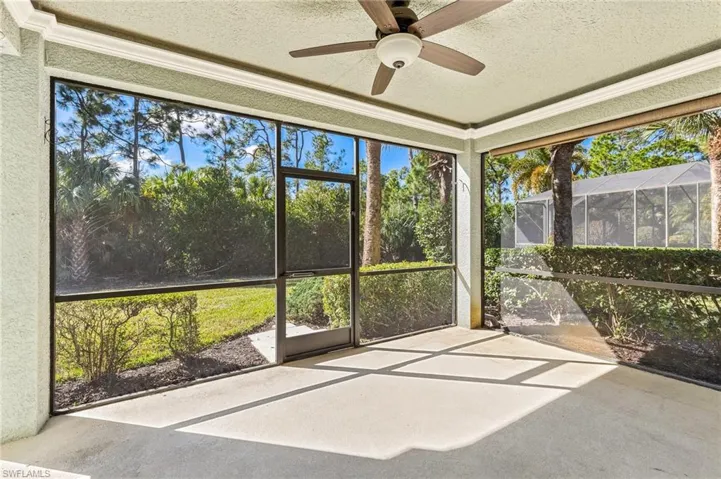 Unfurnished sunroom featuring a ceiling fan