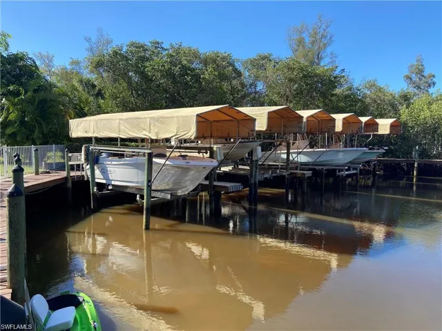Dock area featuring boat lift and a water view