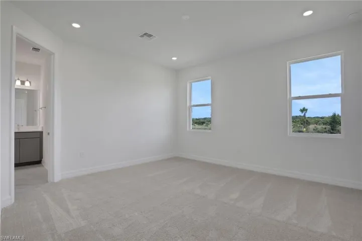 Spare room with light colored carpet and recessed lighting
