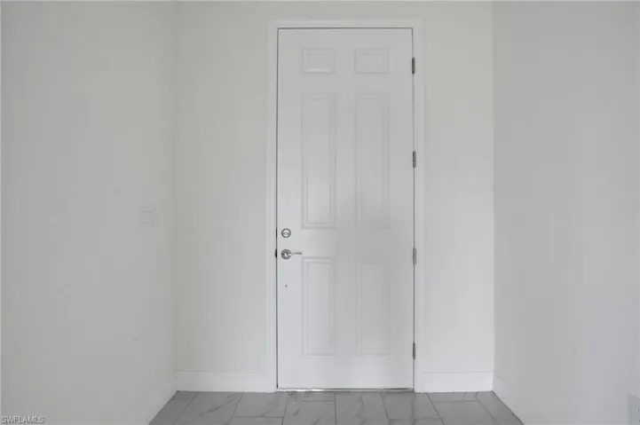Spare room with baseboards and marble finish floors
