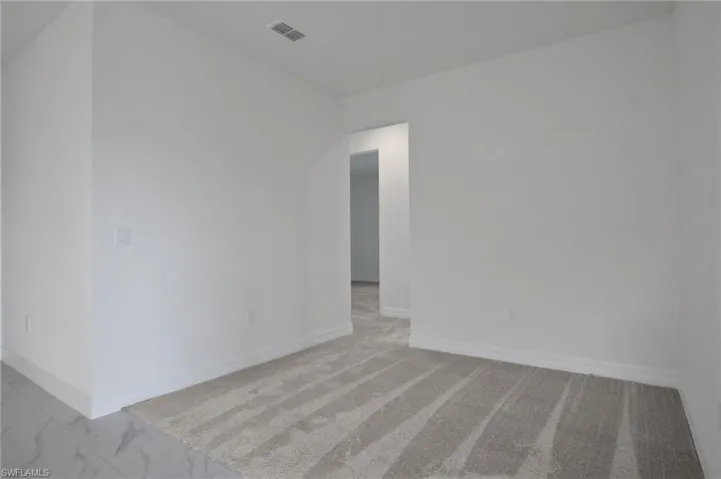 Unfurnished room with baseboards and light marble finish flooring