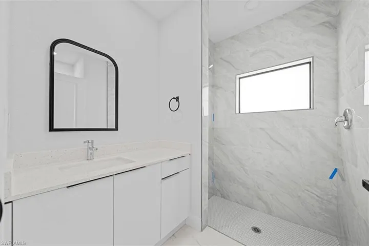 Vanity with a light-toned countertop and an integrated sink