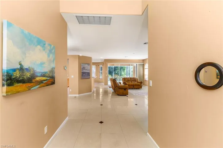 Hallway featuring tile floors looking into the home from the entrance