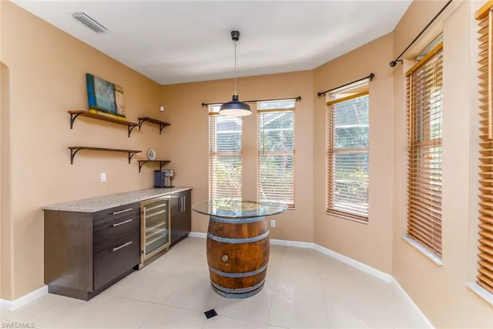 Coffee & Wine Nook off from the kitchen with builtin wine cooler and wine barrel table
