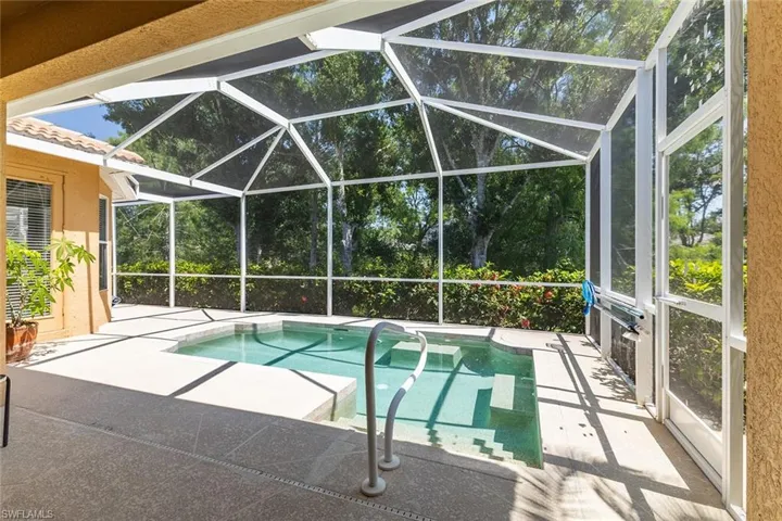 View of swimming pool with a patio screened lanai