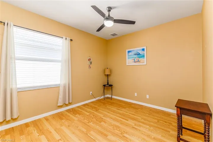 Bedroom 3 with ceiling fan and light hardwood style flooring