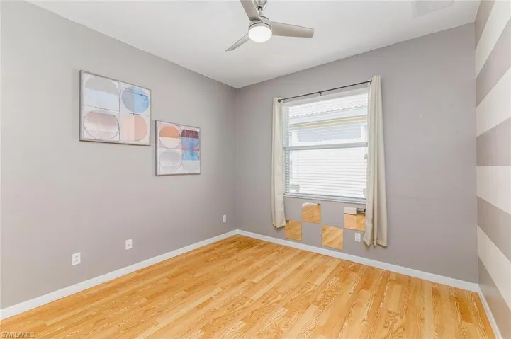 Bedroom 2  featuring ceiling fan and light hardwood style floors