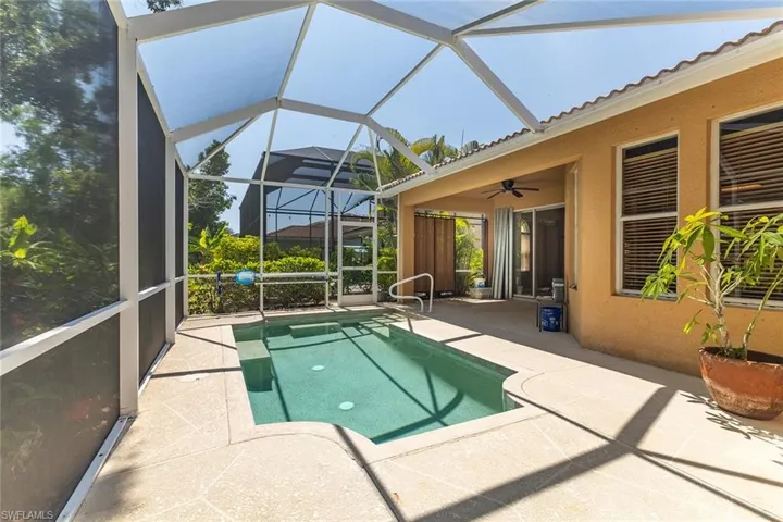 View of pool featuring a patio, screened lanai