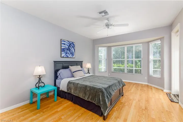 Bedroom with ceiling fan and light hardwood style flooring