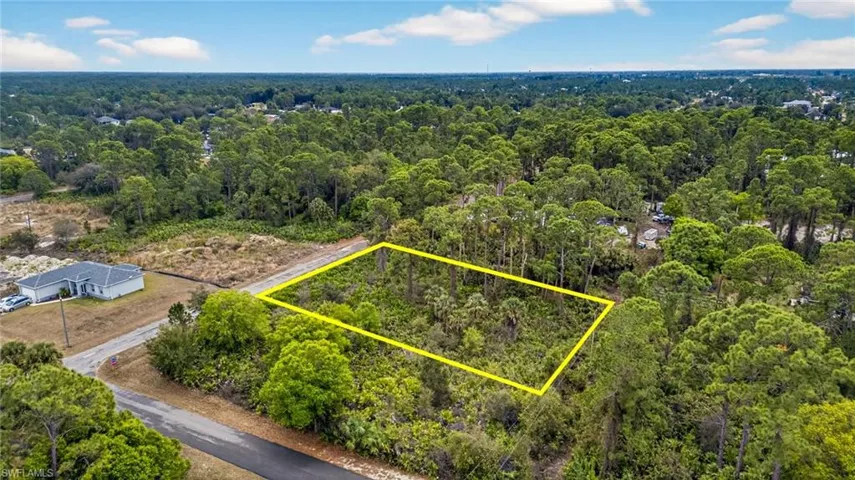 View of property location featuring property boundaries highlighted and a heavily wooded area