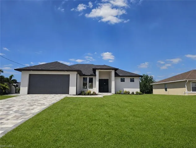 Contemporary single-story residence featuring a dark shingle roof, white stucco exterior, and a two-car garage with a dark gray door