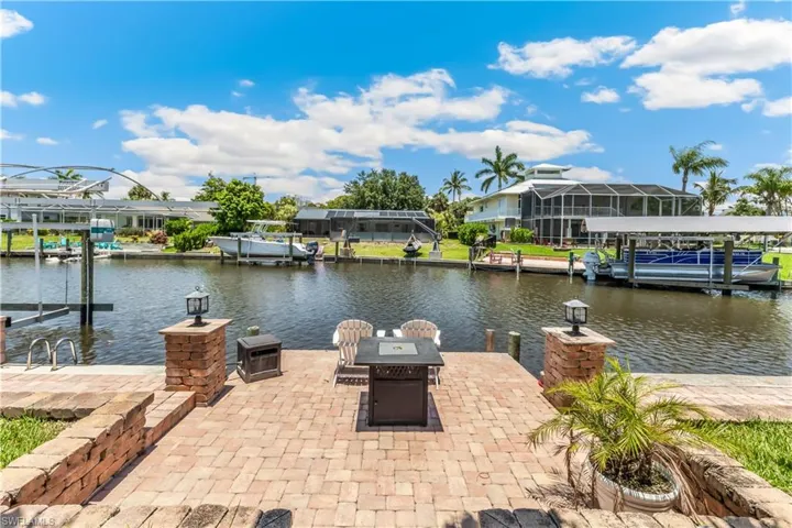Dock area with a lanai and a water view