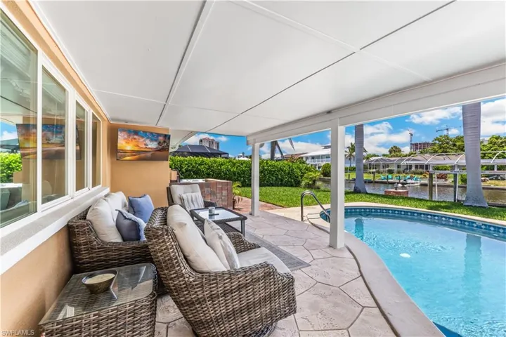 View of swimming pool with a patio and an outdoor living space