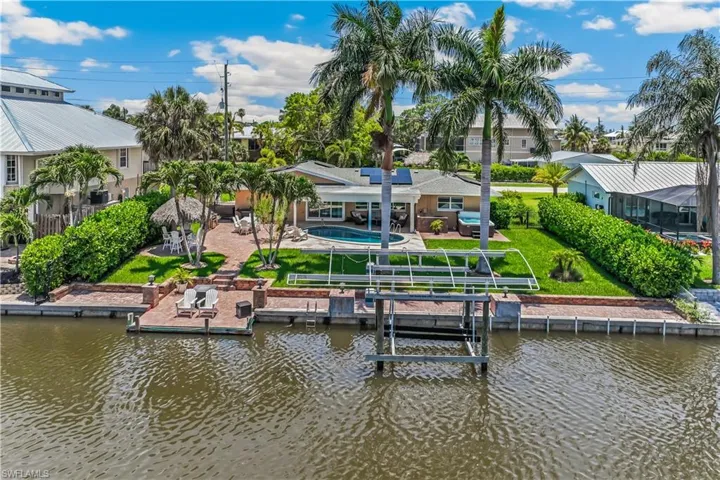 Dock area featuring a patio, a water view, and a yard