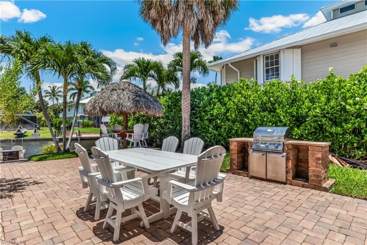 View of patio / terrace featuring an outdoor kitchen, a water view, and area for grilling