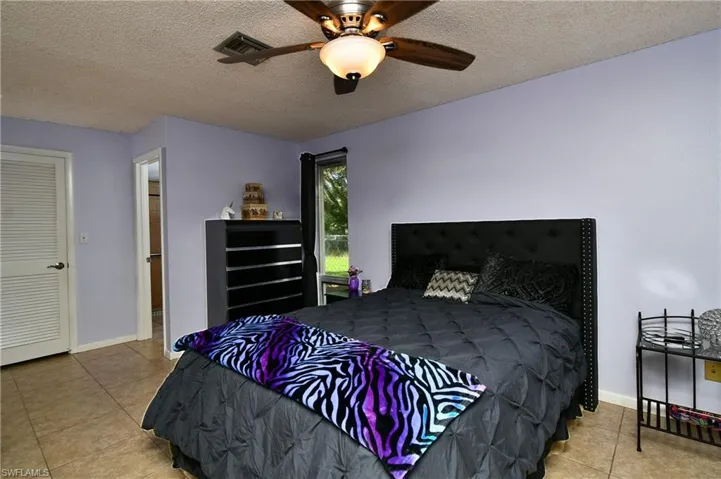 Large Master Bedroom with walk in closet, bathroom and double sliders to Lanai