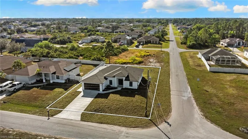 Aerial view of residential area with property parcel outlined