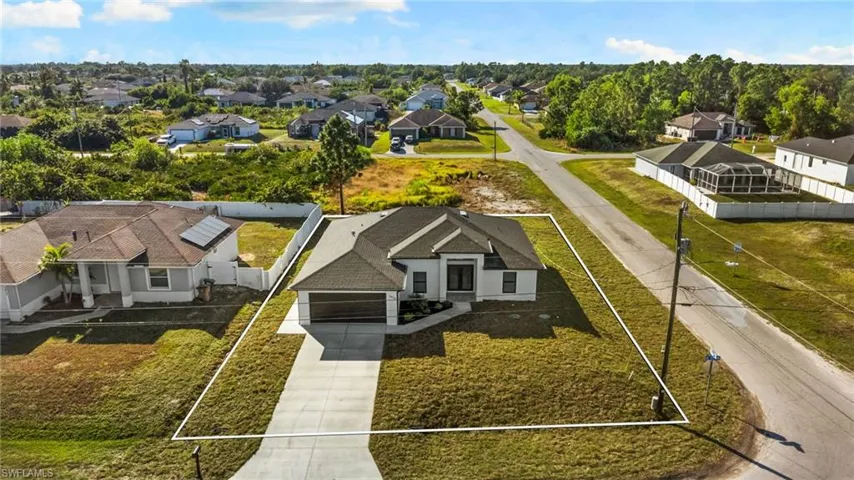 Aerial perspective of suburban area featuring property parcel outlined