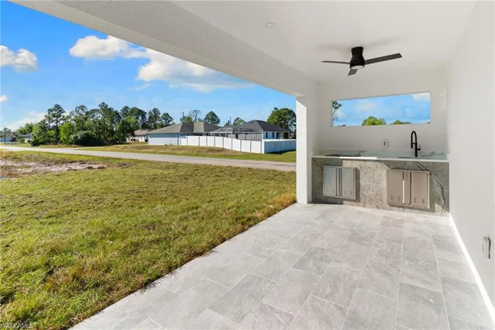 View of patio / terrace featuring an outdoor kitchen and ceiling fan