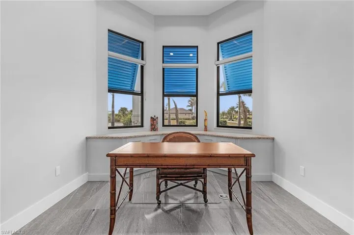 Home office with light hardwood / wood-style flooring and plenty of natural light