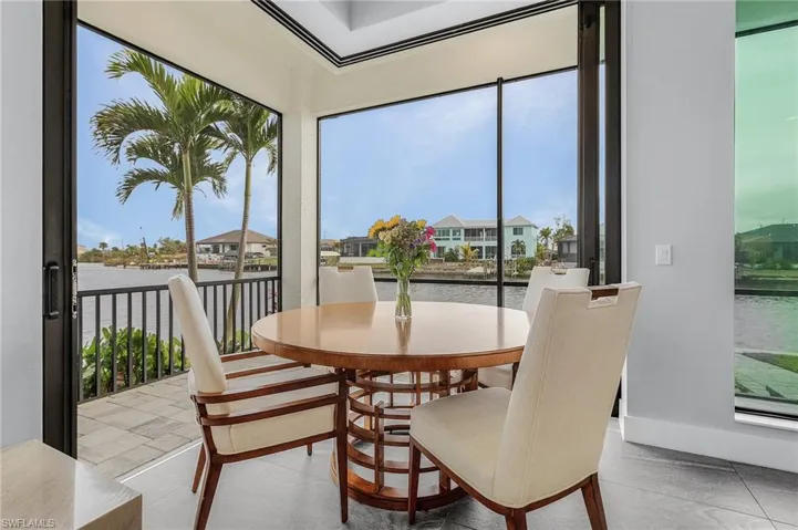 Tiled dining room with a water view