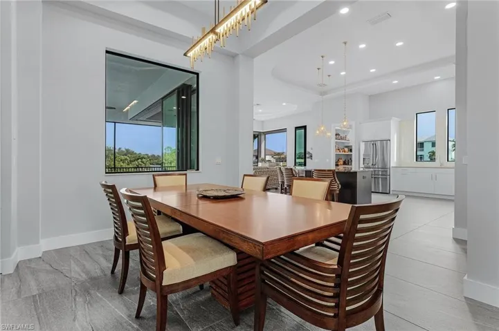 Tiled dining area with a chandelier