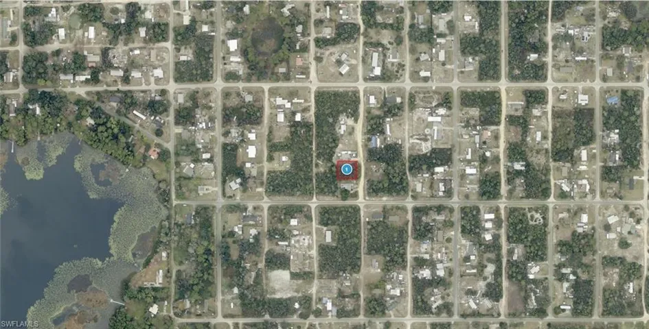 Aerial Map. Illustrating the property's location within a grid-patterned development and its proximity to a body of water