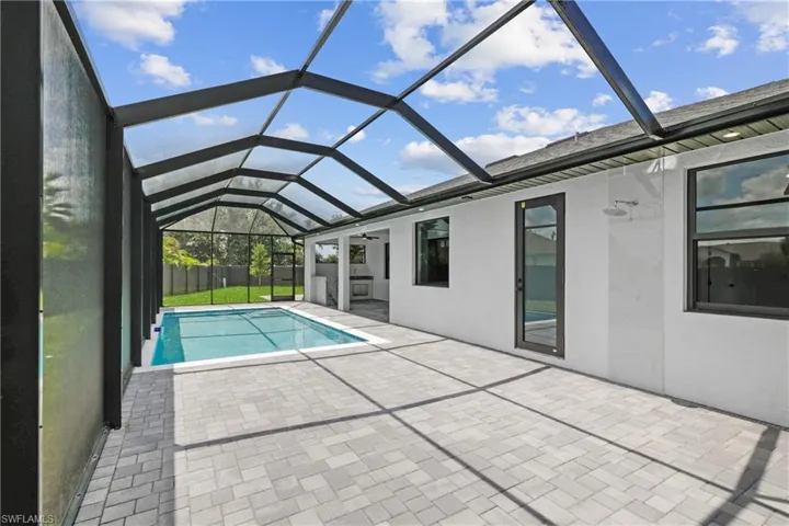 View of pool with a patio and a lanai