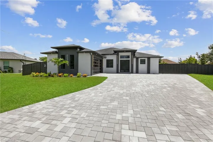 Prairie-style home featuring a front lawn