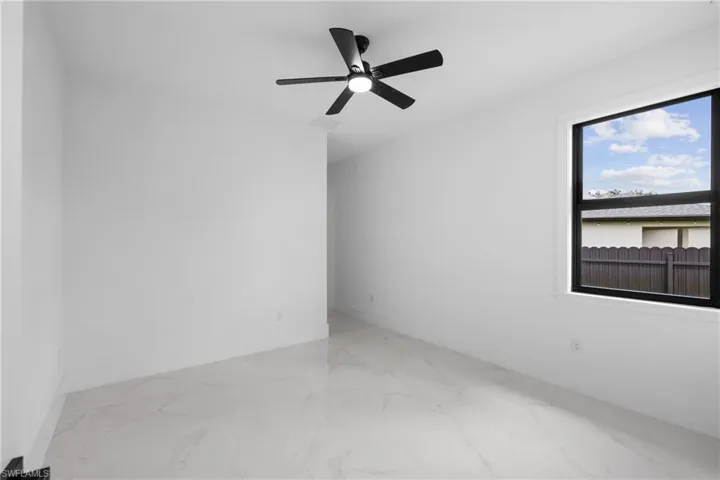 Unfurnished room featuring ceiling fan