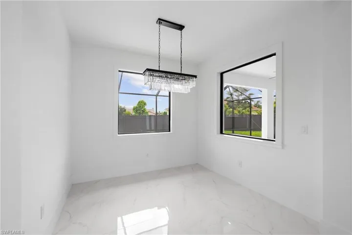 Unfurnished dining area featuring a notable chandelier