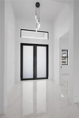 Unfurnished room featuring french doors