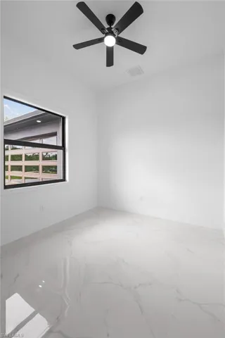 Unfurnished room featuring ceiling fan