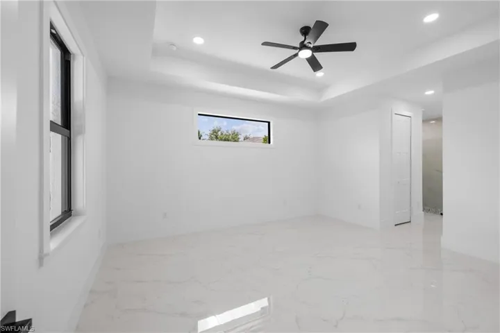 Spare room with ceiling fan and a raised ceiling